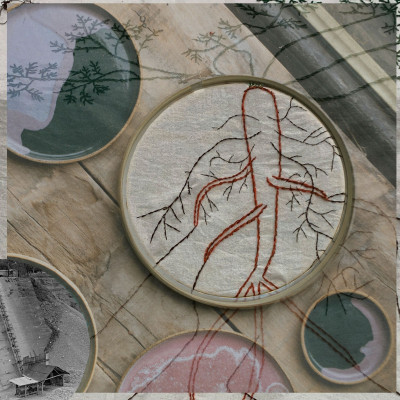 Eine gestickte Karotte im Stickrahmen